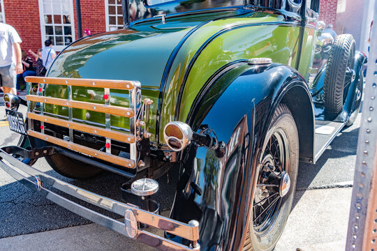 Rear view of a vintage 1927 Ford Model A car parked on a city street.