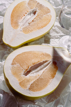 Artistic composition of sliced pomelo on paper