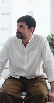 Man, worry and nervous on hospital bed for consultation, thinking or waiting for medical results. Mature person, stress and anxiety for checkup, assessment or visit at healthcare services at clinic
