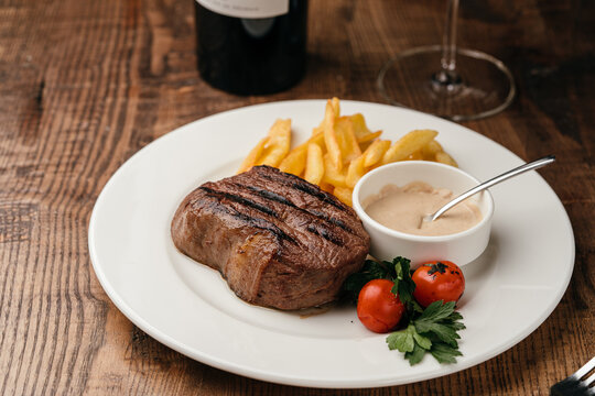 Beef steak with pepper sauce and French fries