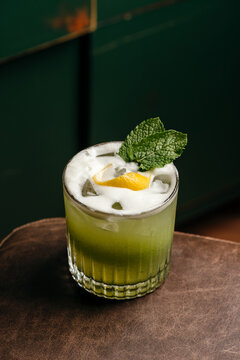 Refreshing cocktail with gin and lemon twist