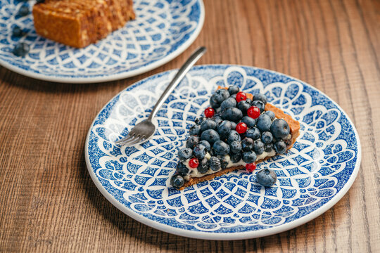 Slice of pie with blueberries and red currants