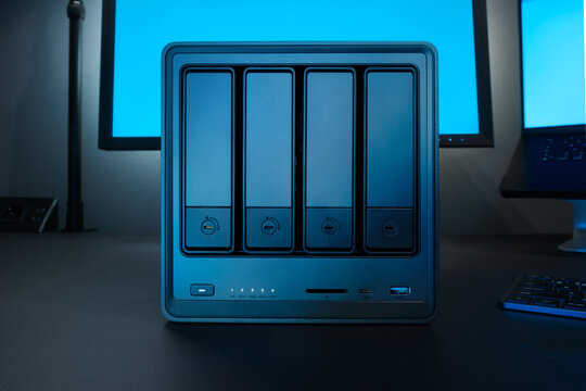 Five Bay NAS Server With Front Drive Bays Highlighted By Blue Desk Setup