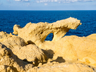 Sculptural rock formation with hole and sea view at Zebbug on Gozo, Malta