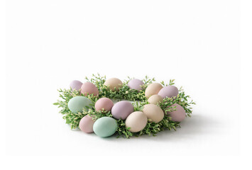 Pastel Easter eggs arranged in a green wreath on a white background. Minimal spring composition with soft colors, festive mood and copy space for seasonal design.
