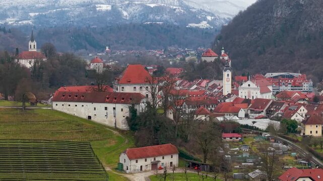 Scenic View of Kamnik Castle and Vineyards with Slovenian Alps Background. Medieval Mali Grad Fortress, Terraced Vineyard Rows and Snowy Mountain Peaks. Alpine Aesthetics in Slovenia 4K
