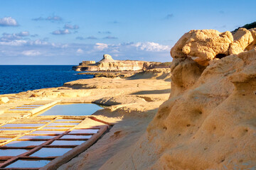 Natural and cultural landscape near Zebbug on Gozo, Malta, with salt pans, sea and striking rock formation. Perfect for tourism, island scenery and Mediterranean atmosphere