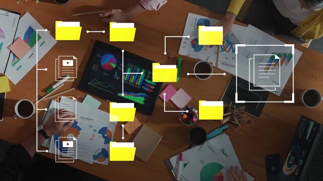 Group Collaboration on Business Strategy with Charts, Graphics, and Sticky Notes on Wooden Desk in Modern Office Setting Gluon.