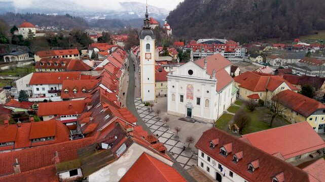 Aerial View of Kamnik Old Town Slovenia. Drone Flight Over Mali Grad Castle and Central Church Towards Medieval Streets. Scenic Alpine Cityscape in Slovenian Alps, European Travel Architecture 4K