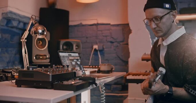 Professional musician plays instruments in the studio, sound recording process