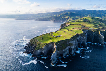 High ocean cliffs and volcanic rock formations along Cape Cintrao on Sao Miguel Island, Azores, drone footage