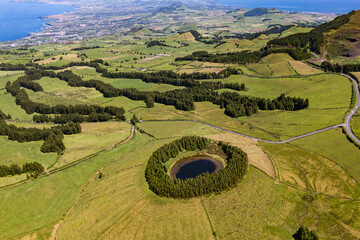 Drone view over round Pau Pique lake surrounded in beautiful green landscape on Sao Miguel Island, Portuguese Azores