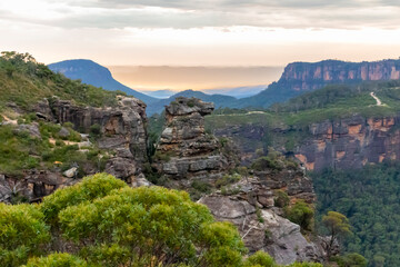 Photograph at sunrise of rock formations heading into the Megalong Valley taken from Boars Head lookout near Katoomba in the Blue Mountains in New South Wales, Australia.