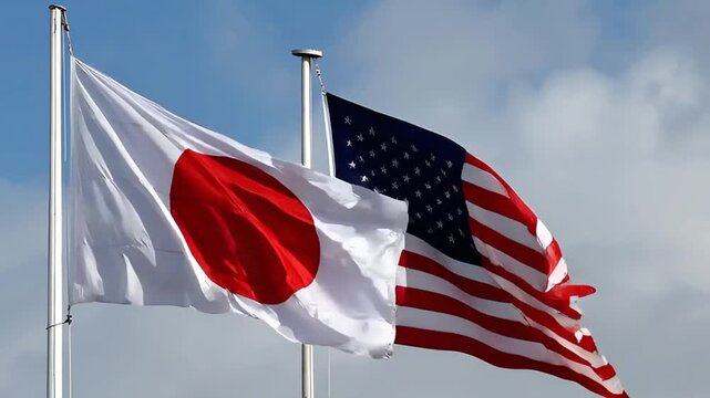flags of japan and united states of america waving on wind against blue sky with clouds