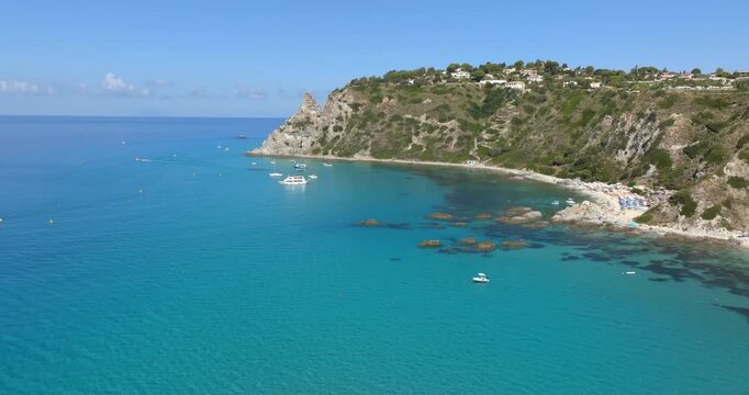Aerial view of Capo Vaticano, in Calabria, southern Italy. It is a majestic, jagged limestone cliff overlooking the turquoise and crystal Mediterranean Sea. It is the symbol of the Coast of the Gods.