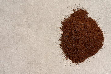 Ground coffee pile on beige background, top view coffee powder texture