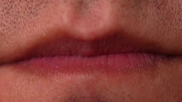 Extreme hyper-detailed macro close-up of closed neutral human lips. The shot captures every fine natural crease and texture of the lip surface, the surrounding skin, visible pores, and the dark shadow