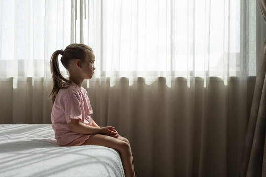 Sad Child Sitting Alone by Window &ndash; Mental Health, Anxiety and Loneliness in Childhood

