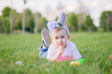 Smiling Boy Celebrating Easter Outdoors with Egg Hunt Basket