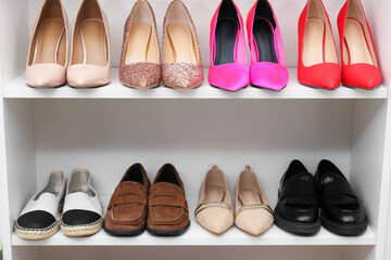 Fototapeta premium Shoe storage. Shelving unit with different footwear indoors, closeup