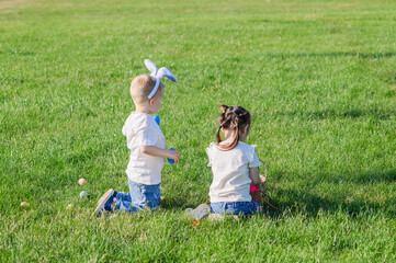 Kids Hunting Easter Eggs Outdoors on Sunny Spring Day