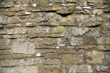 Fototapeta premium Old stone wall bathed in warm sunlight