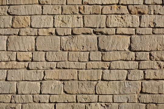 Old stone wall bathed in warm sunlight