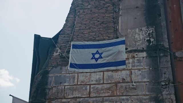 The flag of Israel roped up to an old building. Rome, Italy.
