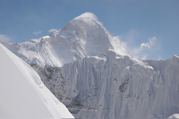 Majestic snow covered Himalayan peak near Island Peak under clear blue sky.