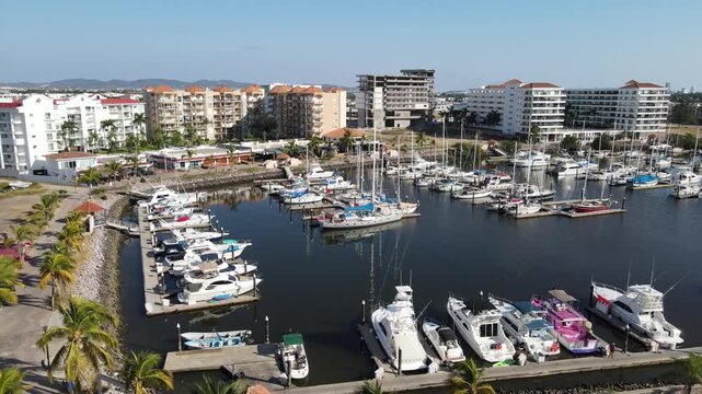 Cinematic golden hour skyline of Marina Mazatlan with luxury buildings and ocean view.