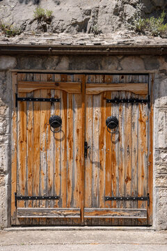 Old wooden doors on a stone building in Blagaj.