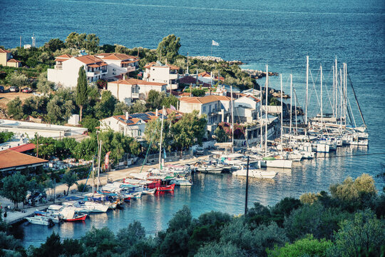 Alonissos, Greece - July 5th, 2022: Aerial sunset view of Steni Vala port and homes