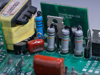 A detailed close‑up of a cylindrical resistor on a printed circuit board.