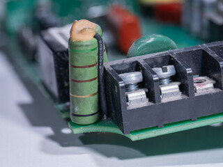 A detailed close‑up of a cylindrical resistor on a printed circuit board.