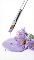 Purple paint and brush beside fresh purple flowers on a white background