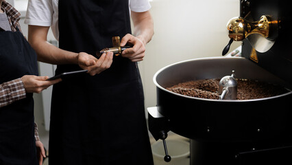 Coffee factory operations, male and female workers inspecting quality and roasting process