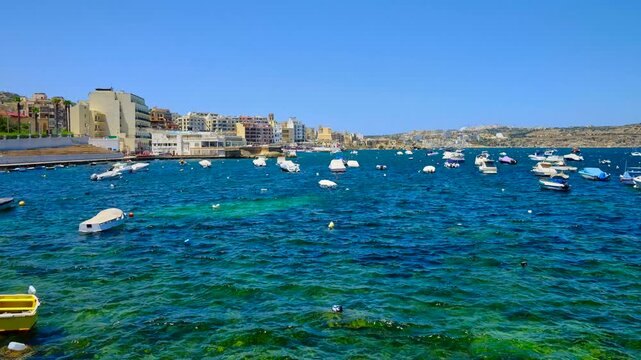Timelapse of the harbor with boats in Bugibba, Malta