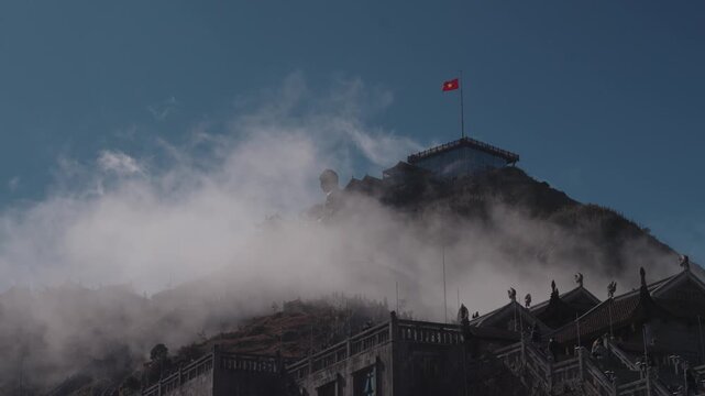 Temple architecture at the Fansipan summit in Sapa, Vietnam, featuring traditional roofs and stone structures set against clear blue sky and high-altitude mountain atmosphere.