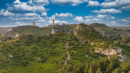 Castle ruins in Olsztyn near Częstochowa captured in golden hour light, aerial drone view over limestone rocks and historic fortress in Poland © Konrad Kerker