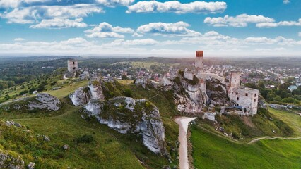 Castle ruins in Olsztyn near Częstochowa captured in golden hour light, aerial drone view over limestone rocks and historic fortress in Poland © Konrad Kerker