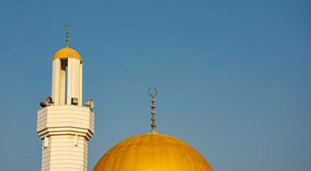 Minaret and Dome of Mosque Against Clear Blue Sky