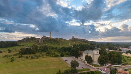 Castle ruins in Olsztyn near Częstochowa captured in golden hour light, aerial drone view over limestone rocks and historic fortress in Poland © Konrad Kerker