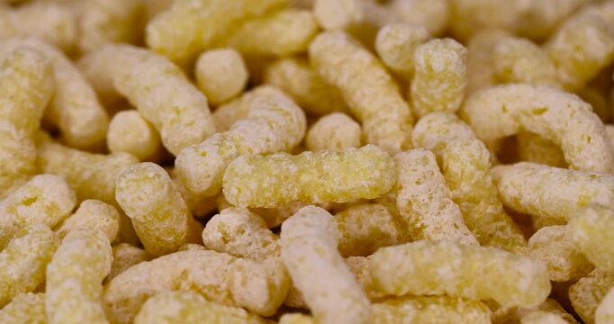 large sweet sticks of corn flour with added sugar for quick cooking with milk or yogurt, ready-to-eat corn sticks scattered on food paper