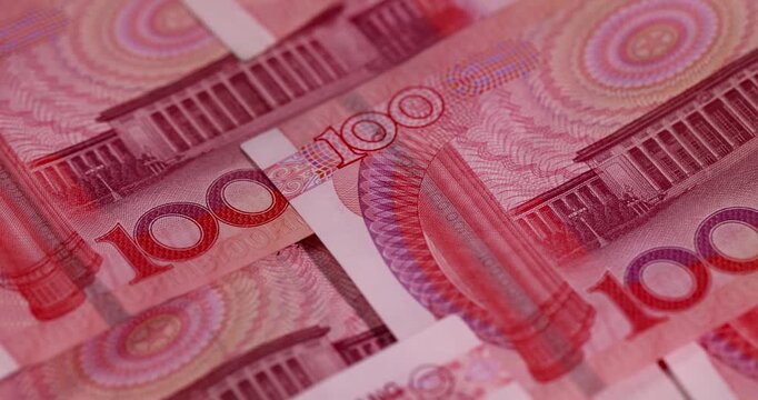 Chinese money with a face value of 100 yuan, cash in red with national symbols of China, closeup