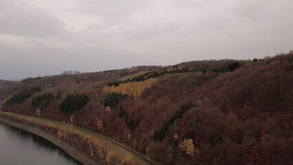 Obraz premium Autumn Lake Aerial View with Soft Light and Rolling Landscape