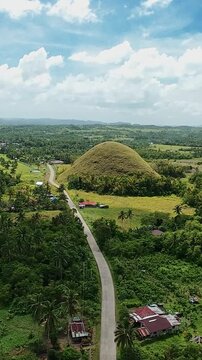 Vertical Screen, Philippines, Bohol Island Aerial Road Approach Toward Chocolate Hill With Scattered Houses And Palm Trees, Village Setting And Agricultural Fields, Local Commuter And Farmer