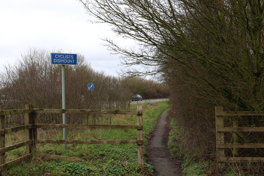 A cyclist dismount sign by the carriageway.  