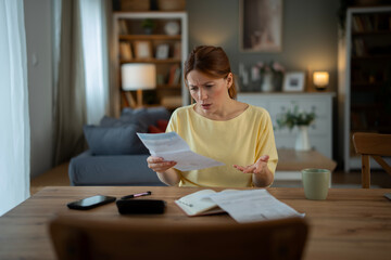 Woman feeling stressed getting bad news about bills