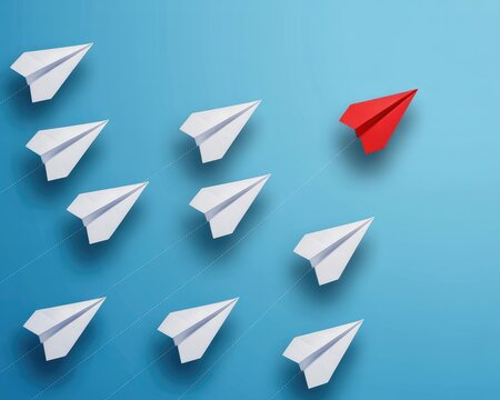 Red paper airplane leads white planes on blue background symbolizing innovation and leadership