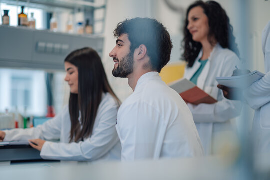 Medical students and scientists collaborating during lab research